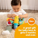 Infant playing with Lamaze Freddie the Firefly, a colorful plush toy designed for sensory exploration.