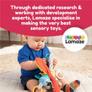 Baby playing with Lamaze Freddie the Firefly toy, featuring bright colors and various textures, fostering sensory development.