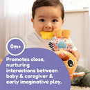 Baby holds a Lamaze Lovey The Pug Clip & Go toy while chewing on a yellow flower-shaped teether, promoting nurturing interactions.