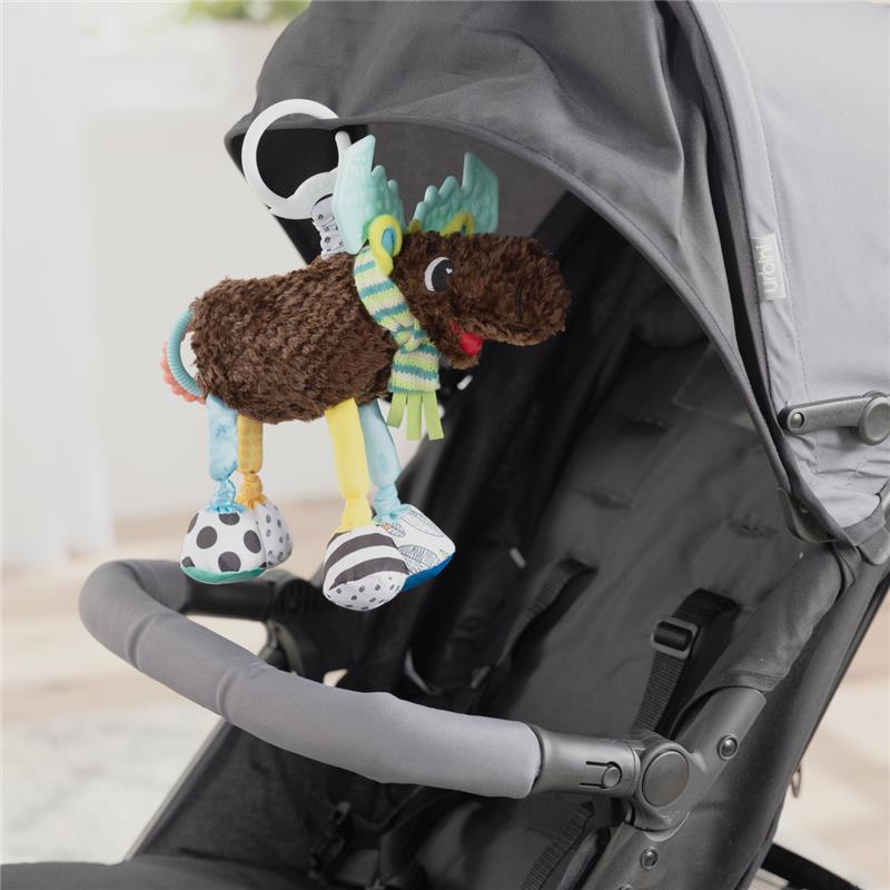 Colorful plush moose toy with a clip, featuring patterned legs and a scarf, attached to a stroller.