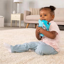 Toddler sitting on a plush carpet, hugging a blue Puffaboo™ Elephant sensory toy with patterned ears.