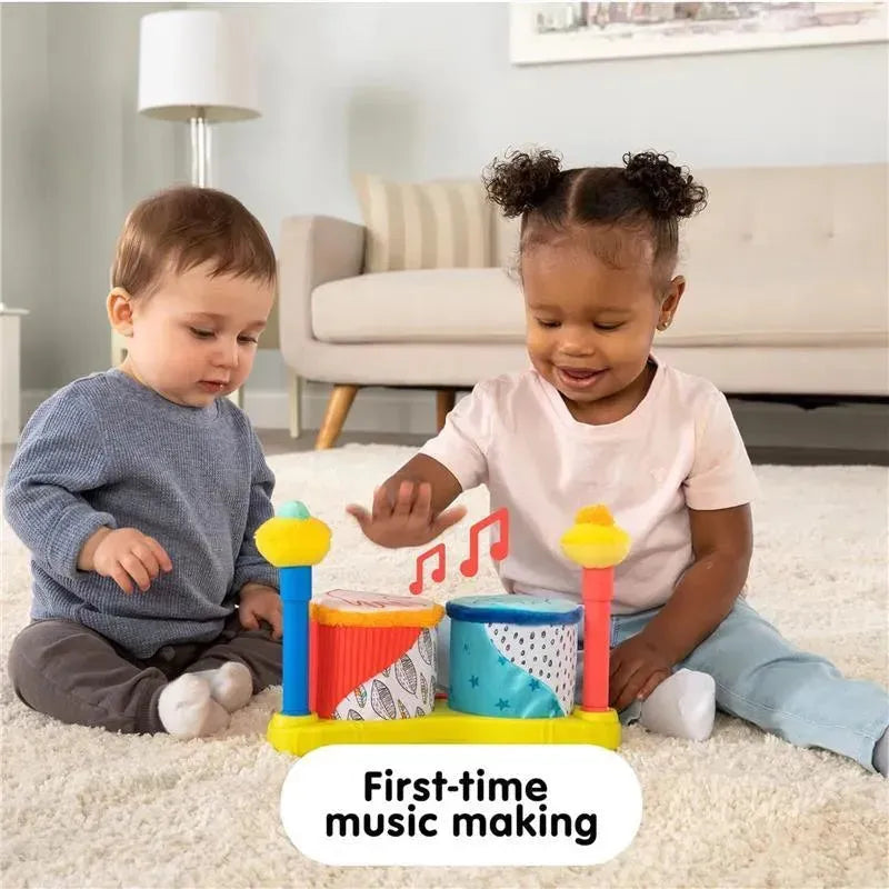 Two toddlers play with the Lamaze Squeeze Beats First Drum Set, making music together with colorful drums.