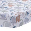 Crib sheet featuring a playful dinosaur pattern in blue, gray, and soft pastels for nursery bedding.