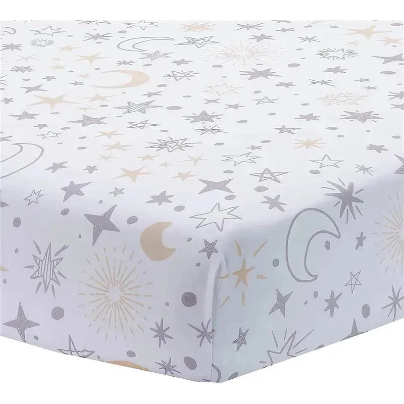 Crib bedding set featuring a white fabric with gray and gold stars, moons, and cosmic designs.