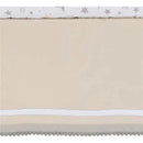 Lambs & Ivy baby crib bedding set featuring a light beige quilt with a whimsical star print top and decorative gray pom-pom trim.