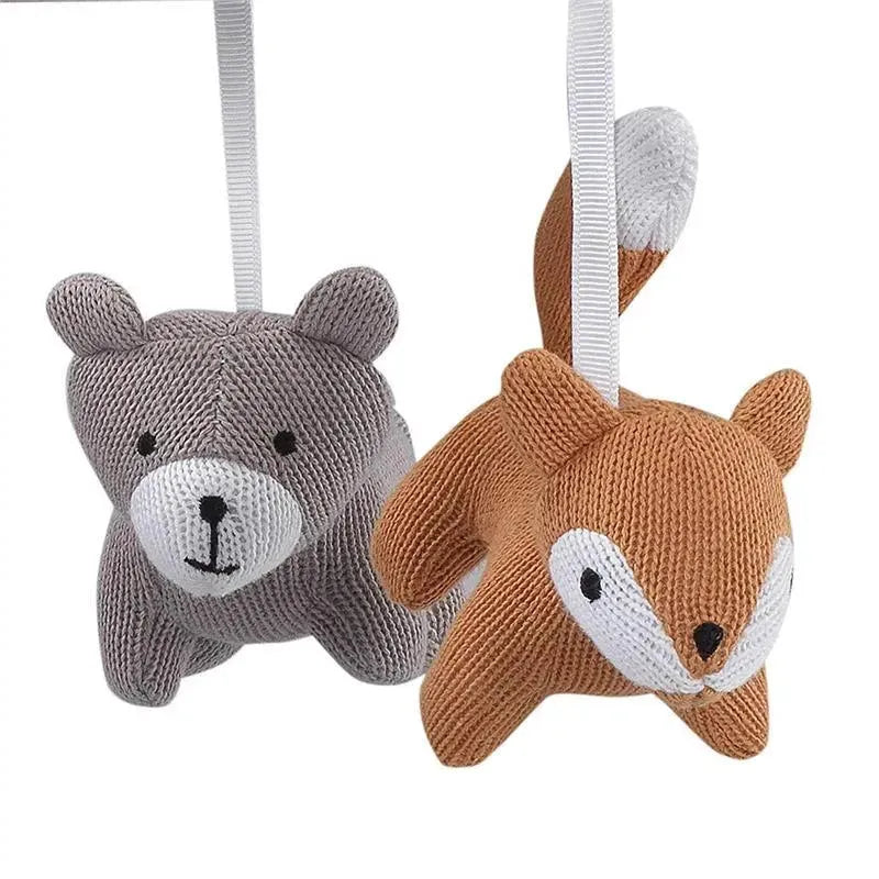 Knitted bear and fox plush figures with hanging ribbons, designed as part of the Lambs & Ivy baby crib mobile.
