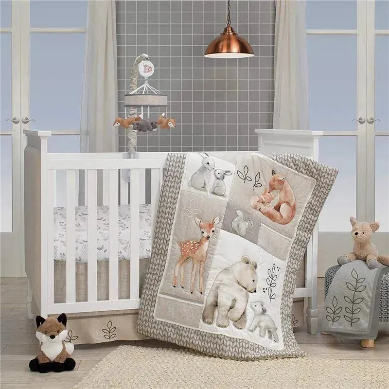 Lambs & Ivy Baby Crib Musical Mobile with woodland animals, a cozy quilt featuring forest creatures, and plush toys.