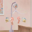 Musical crib mobile featuring plush seahorses and a fish, designed for babies, with a Little Mermaid theme.