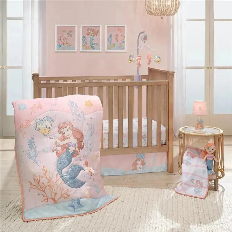 Disney Baby The Little Mermaid crib mobile and bedding set featuring Ariel and Flounder in a pastel nursery setting.