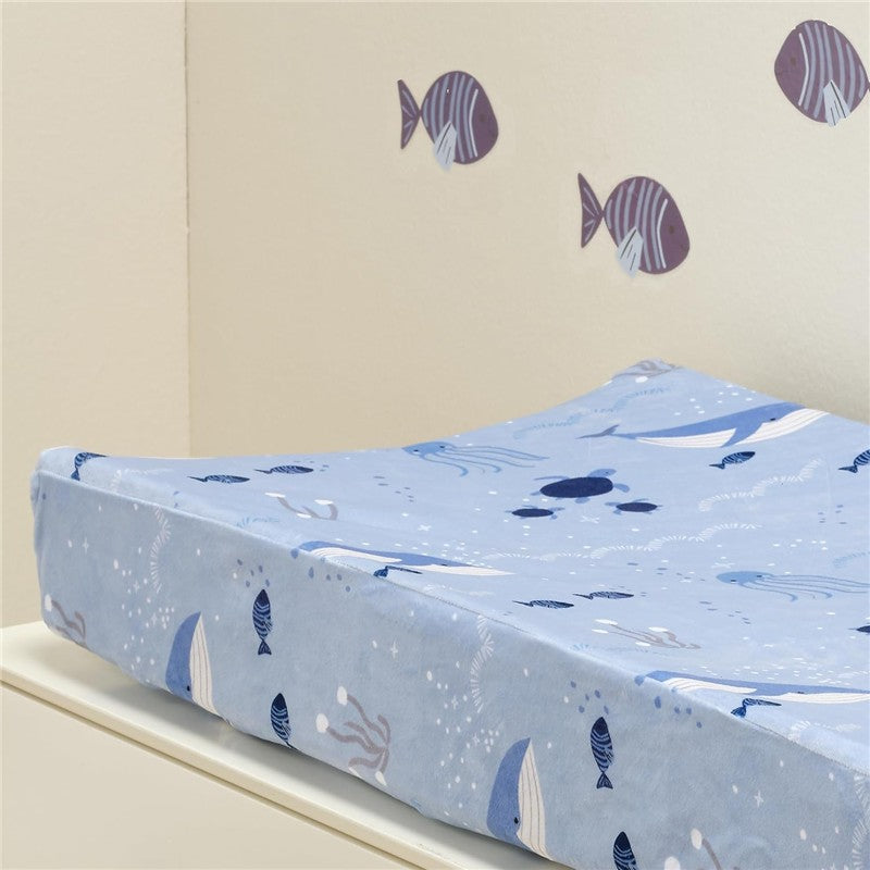 Lambs & Ivy Bubble & Squirt Changing Pad Cover in blue, featuring whimsical sea life patterns including fish and jellyfish.