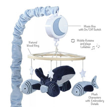 Musical mobile featuring plush whale and fish characters, rotating with lullabies, attached to a natural wood ring.