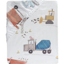 Fitted crib sheet featuring colorful construction vehicles like diggers and trucks on a light background.