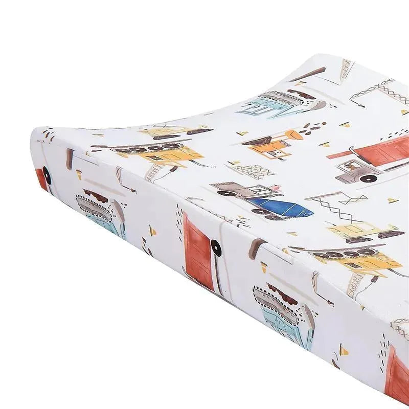 Changing pad cover featuring a construction zone theme with colorful trucks and buildings.