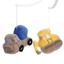 Plush construction vehicle toys in blue and yellow hanging from a white crib mobile, designed for soothing babies.