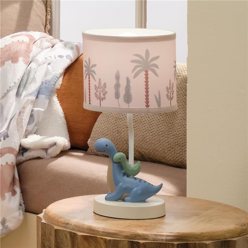 3D dinosaur nursery lamp featuring a blue dinosaur with a green baby dinosaur, topped with a palm tree print shade.