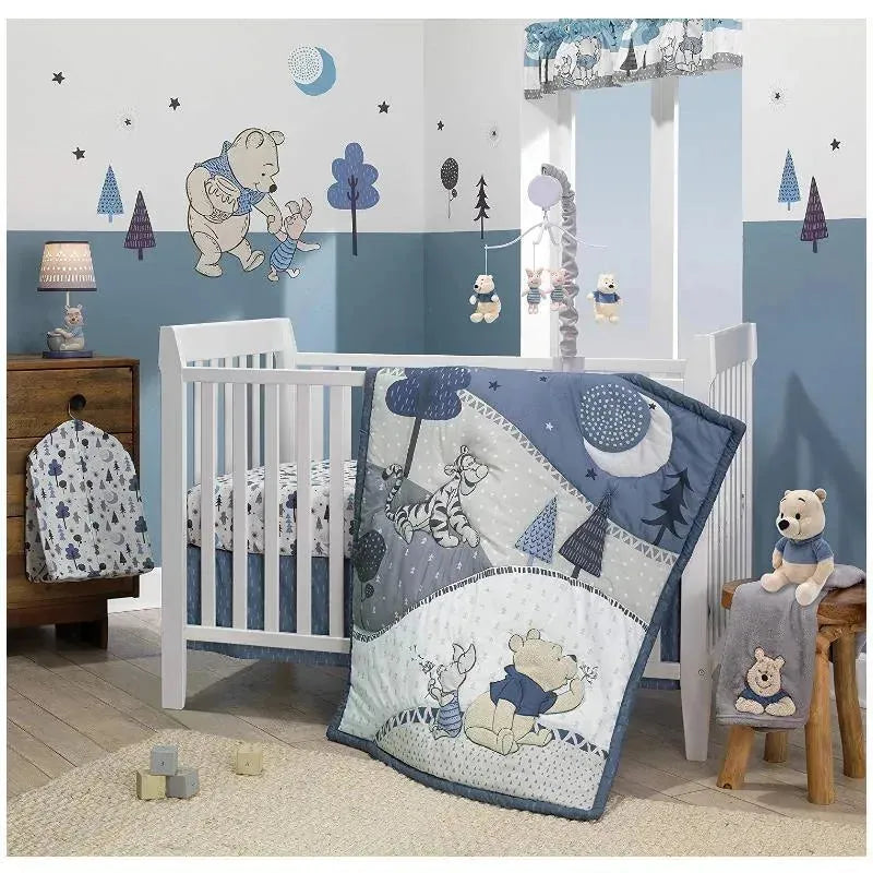 Fitted crib sheet featuring a Disney Baby Forever Pooh design in white and blue with bear and woodland animal patterns.