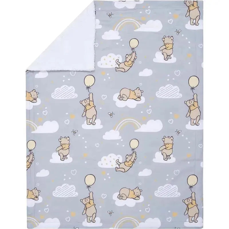 Gray baby blanket featuring cartoon Winnie the Pooh characters playing with balloons among clouds and rainbows.
