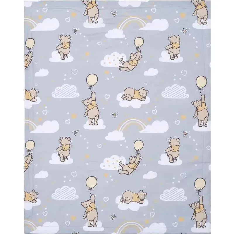Gray baby blanket featuring playful illustrations of Winnie the Pooh holding balloons among clouds and rainbows.