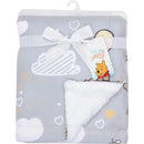 Gray soft sherpa baby blanket featuring a Winnie the Pooh design, tied with a ribbon and a tag.