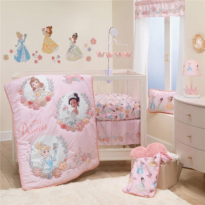 Lambs & Ivy Disney Princesses nursery crib bedding set featuring a pink quilt, sheets, and wall decals of princesses.