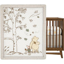 Lambs & Ivy Disney Storytime Pooh 3-Piece Crib Bedding Set featuring Winnie the Pooh and Piglet surrounded by trees and falling leaves.