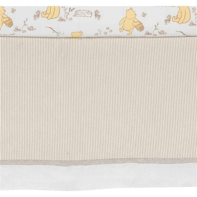 Lambs & Ivy Disney Storytime Pooh crib bedding set featuring a Pooh pattern at the top and soft striped fabric below.