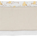 Lambs & Ivy Disney Storytime Pooh crib bedding set featuring a Pooh pattern at the top and soft striped fabric below.
