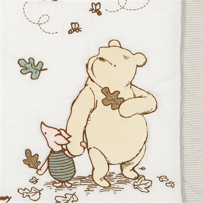 Lambs & Ivy Disney Storytime Pooh 3-Piece Crib Bedding Set featuring Winnie the Pooh holding hands with Piglet, surrounded by autumn leaves.