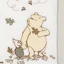 Lambs & Ivy Disney Storytime Pooh 3-Piece Crib Bedding Set featuring Winnie the Pooh holding hands with Piglet, surrounded by autumn leaves.