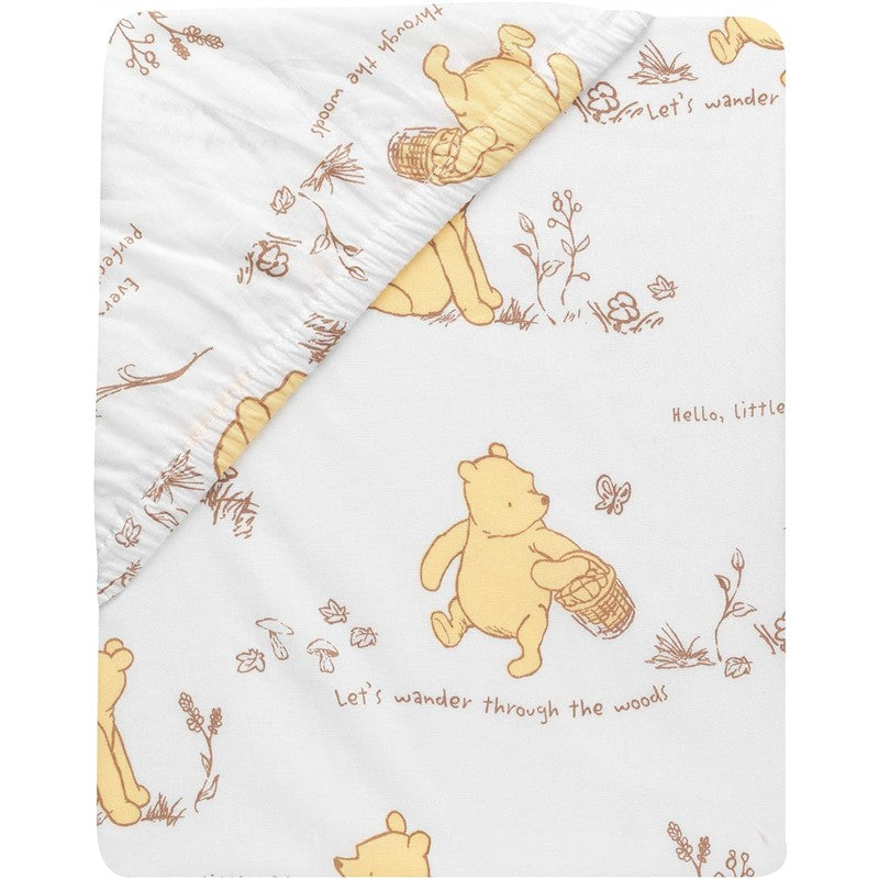 Lambs & Ivy Disney Storytime Pooh crib blanket featuring Winnie the Pooh with a basket, surrounded by text and nature illustrations.