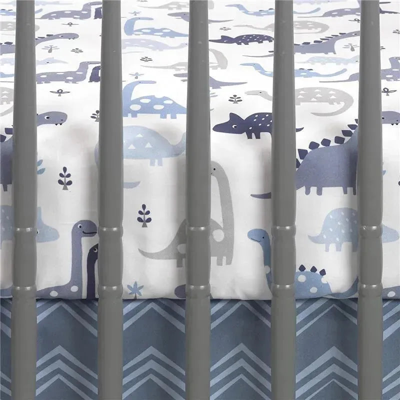 Fitted crib sheet featuring a dinosaur print in shades of blue and gray, placed in a crib with gray slats.