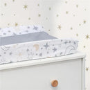 Changing pad covered with a Lambs & Ivy Goodnight Moon design featuring stars and moons, resting on a white dresser.