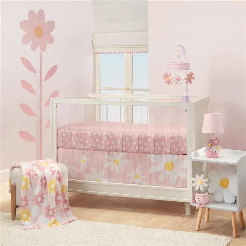 Growth chart wall decals featuring pink daisies and a growth measurement alongside a crib adorned with floral designs.