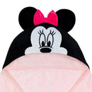 Hooded baby bath towel featuring Minnie Mouse, with a pink body and black hood adorned with ears and a bow.