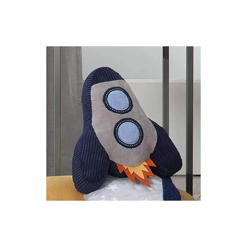 Plush rocket ship throw pillow in blue and grey with circular window details and orange flame accents, ideal for nursery decor.