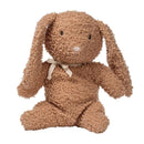 Honey-colored plush bunny with long ears and a fabric bow, made from organic cotton, designed for infants.
