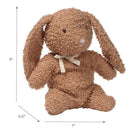 Organic cotton brown bunny plush toy with textured fur, sitting position, and a beige ribbon around its neck.