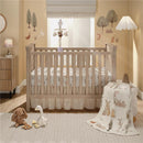 Plush bunny and goose toys on a nursery floor, with a crib featuring a woodland-themed bedding set in a soft-colored room.