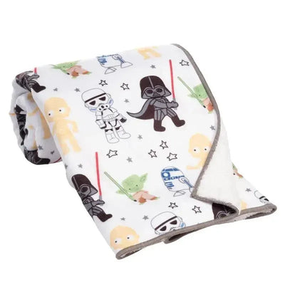 Lambs & Ivy Star Wars Classic Blanket featuring cartoon characters like Darth Vader, Yoda, and R2-D2 on a white background.