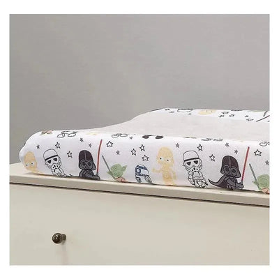 Changing pad cover featuring Star Wars characters like Yoda, Darth Vader, and Stormtrooper, adorned with stars and lightsabers.