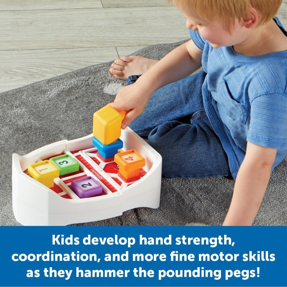 A child plays with the Learning Resources Barnyard Pounding Bench, using a colorful block to hammer pegs.
