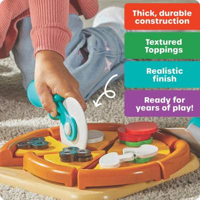 Child using a pizza cutter on a colorful play pizza set, featuring various realistic toppings and a textured finish.