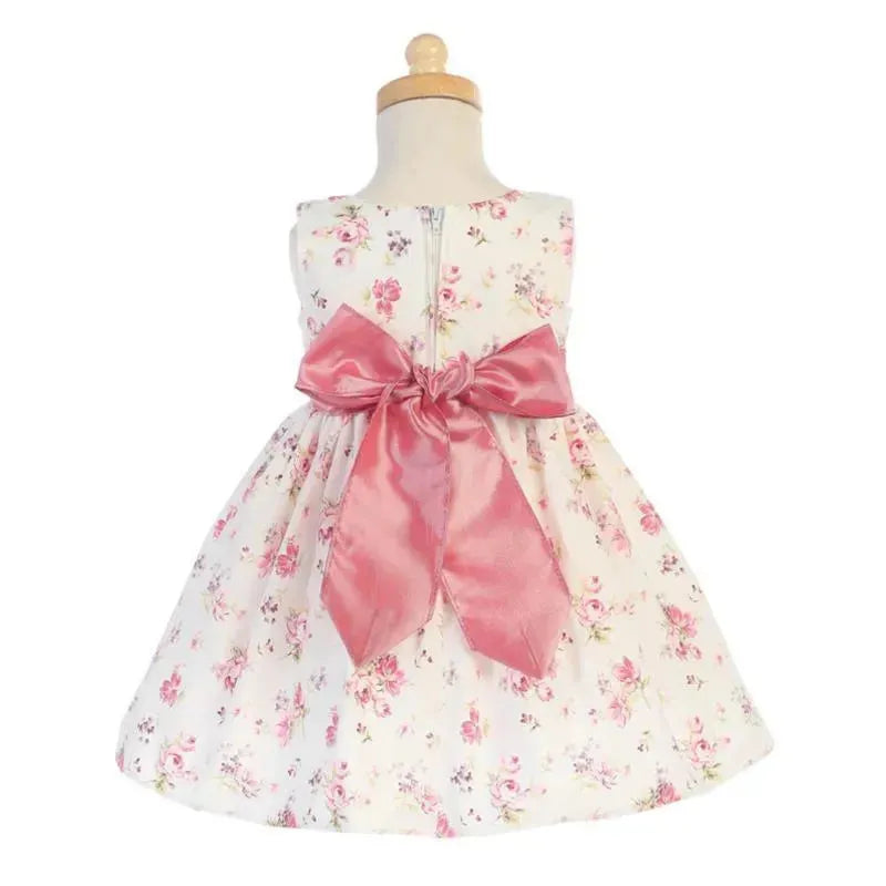 Cotton floral print dress for girls, featuring a pink bow at the back and a zipper closure.