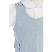 Cotton linen overall set in blue featuring button details, paired with a white collared shirt underneath.
