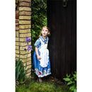 Young girl in a blue Alice in Wonderland dress peeks from behind a door, surrounded by greenery and purple flowers.