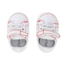 Baby boy sneakers in white with red stitching and Velcro strap, featuring a soft sole for comfort.