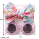 Baby girl summer accessories set featuring floral headband and pink flower-shaped sunglasses.