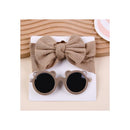 Baby sunglasses and a beige headband set, featuring round black lenses with bear-ear details on the sides.