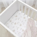 Cotton jersey crib fitted sheet featuring a rainbow sloth design, laid in a white crib with a soft pink blanket.