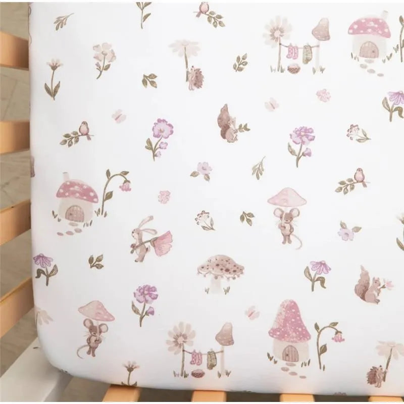 Cotton jersey fitted sheet with whimsical mushroom and animal illustrations in soft pink and earth tones.